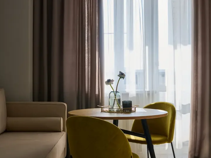 two-mustard-yellow-chairs-standing-by-round-table-2026-03-24-04-27-28-utc